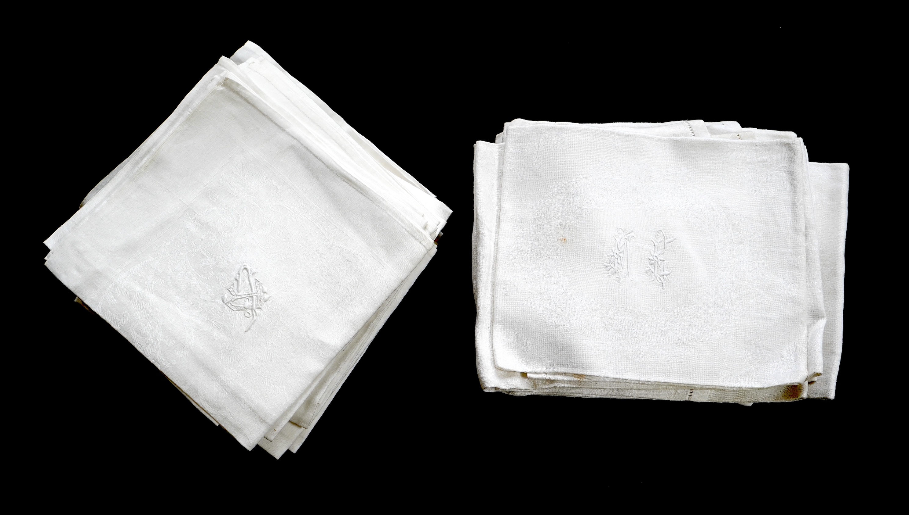 A set of fifteen large 19th century monogrammed damask dinner napkins and set of eight similar sized monogrammed damask dinner napkins, the larger set designed with a wide classical scrolling floral border and a simple d